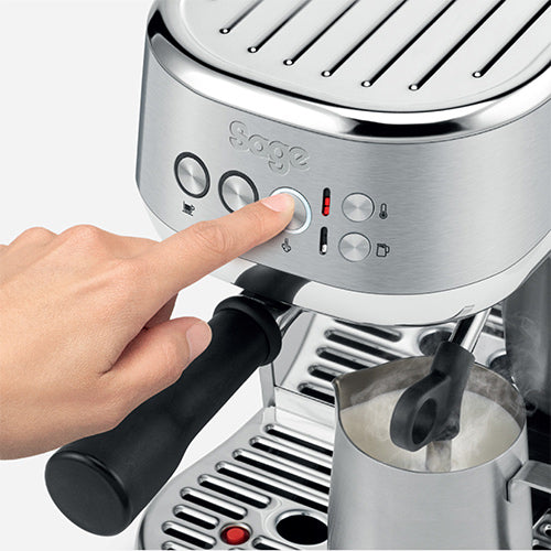 Sage the Bambino Plus automatic steam wand texturing milk in the stainless steel jug, official photography