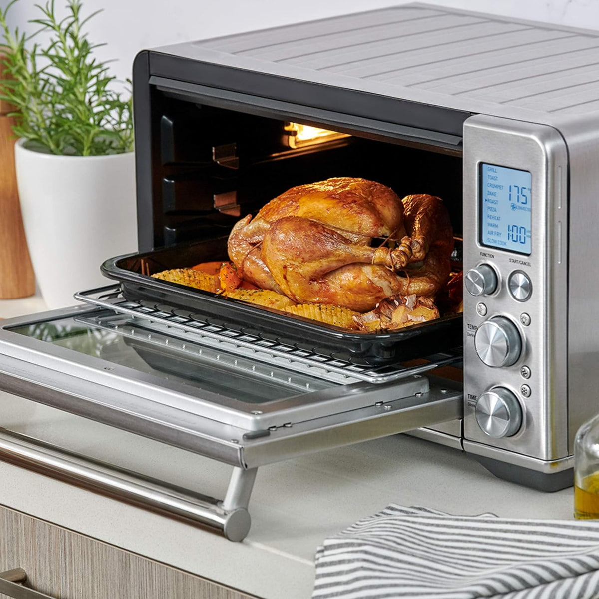 Sage the Smart Oven Air Fryer on a kitchen counter with a roast chicken inside, official lifestyle view