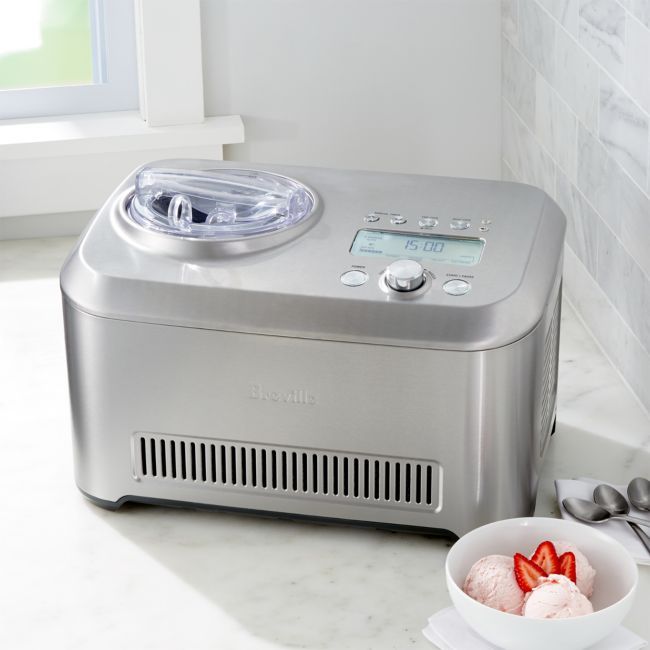 A hand turning the hardness dial on Sage the Smart Scoop with the LCD lit, official detail