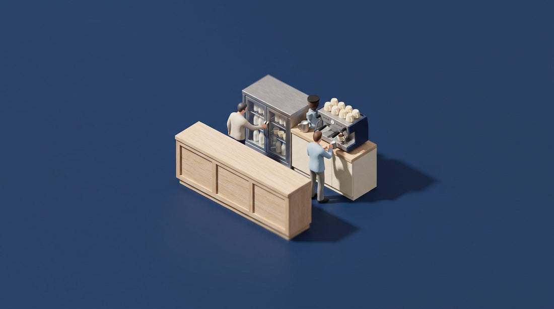 Miniature model of a cafe back bar with a glass-door milk cooler beside a two-group espresso machine, with baristas at work