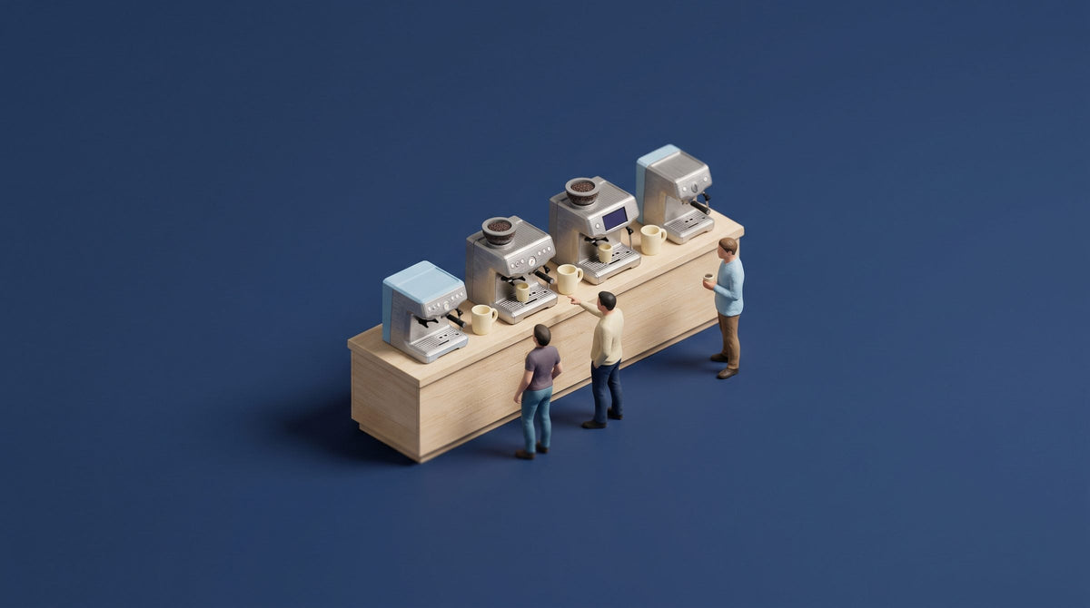 Miniature model of a showroom counter with four home espresso machines of different sizes and three figures browsing them