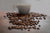 image of coffee cup out of focus and roasted coffee beans scattered across the table 