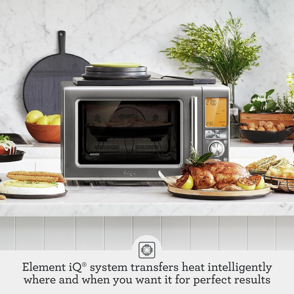 Sage the Combi Wave 3 in 1 on a kitchen counter with a roast chicken and sandwiches, official lifestyle view