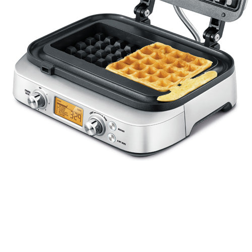 Sage the Smart Waffle Pro open with a golden square waffle on the plate and the moat around it, official view