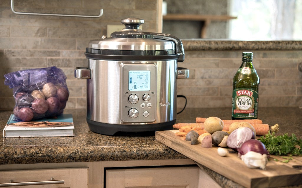 Sage the Fast Slow Pro on a kitchen counter with fresh vegetables, official lifestyle view