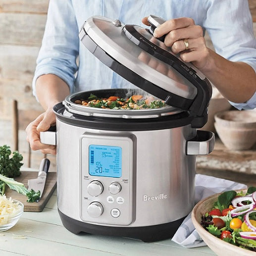 Lifting the hinged lid of Sage the Fast Slow Pro to reveal a vegetable stew, official lifestyle view